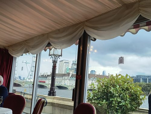 View from the window shows a bridge across the River Thames and the London Eye.