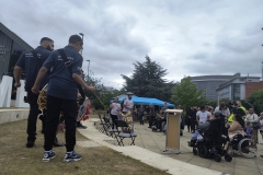 The dhol players performing in front with the crowd watching