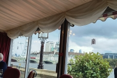 View from the window shows a bridge across the River Thames and the London Eye.