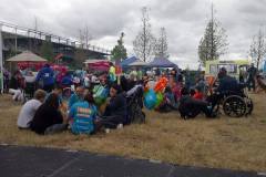 People sitting on the grass enjoying the food and stalls